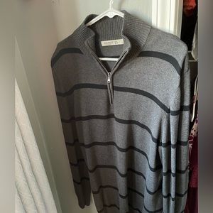 A man’s gray and black striped sweater.